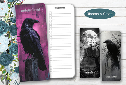 Notebook with a purple cover featuring a black crow and other designs on a white background.